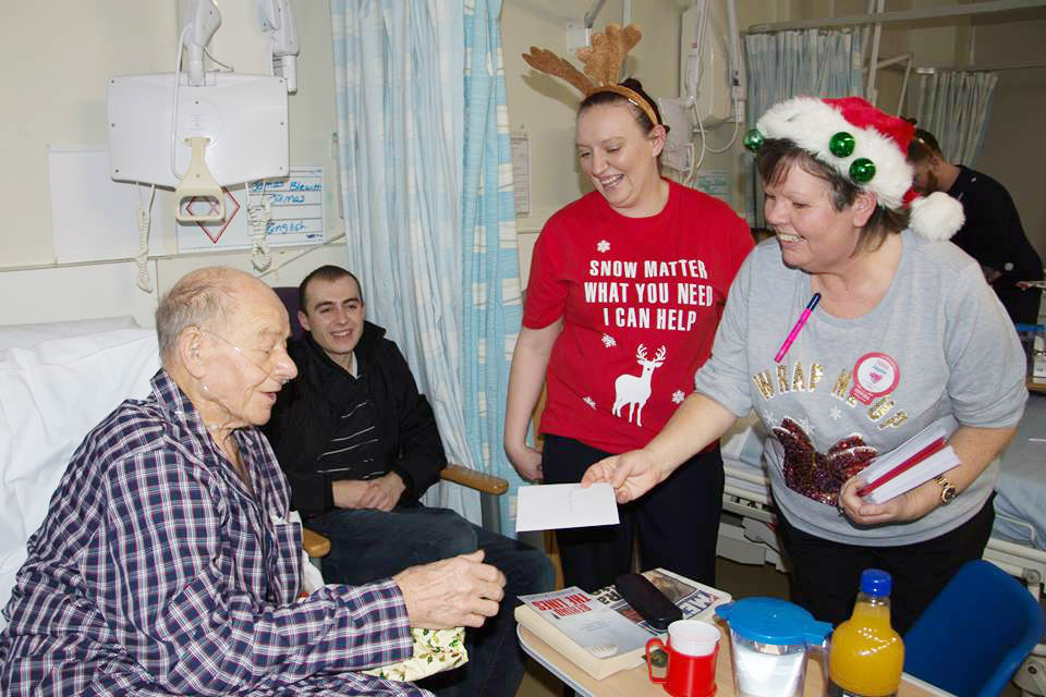 Sandwell Hospital patient Bill receives his gift from Tesco Extra staff.