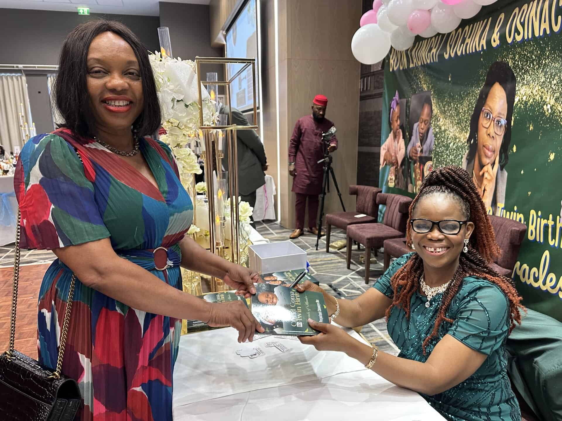 Dr Pep Uke signs a copy of her book for Dr Chizo Agwu