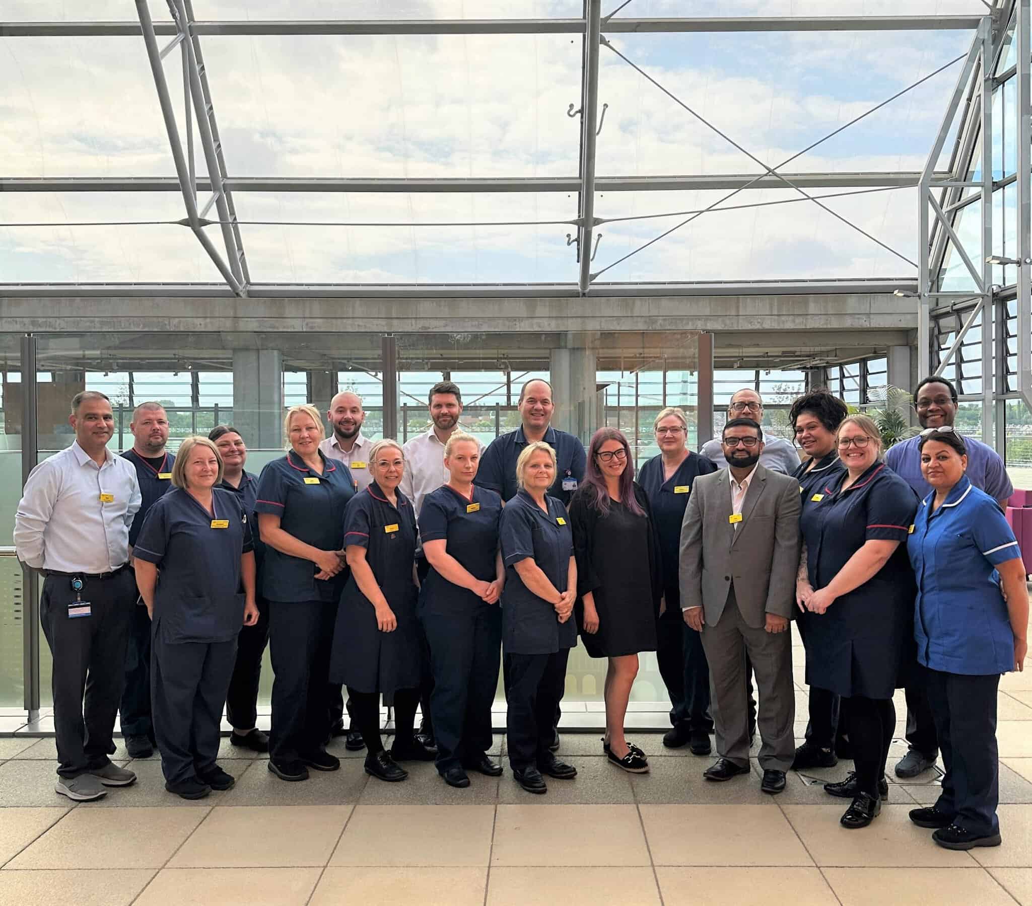 A group of clinical staff in uniforms, posing for a group photo.