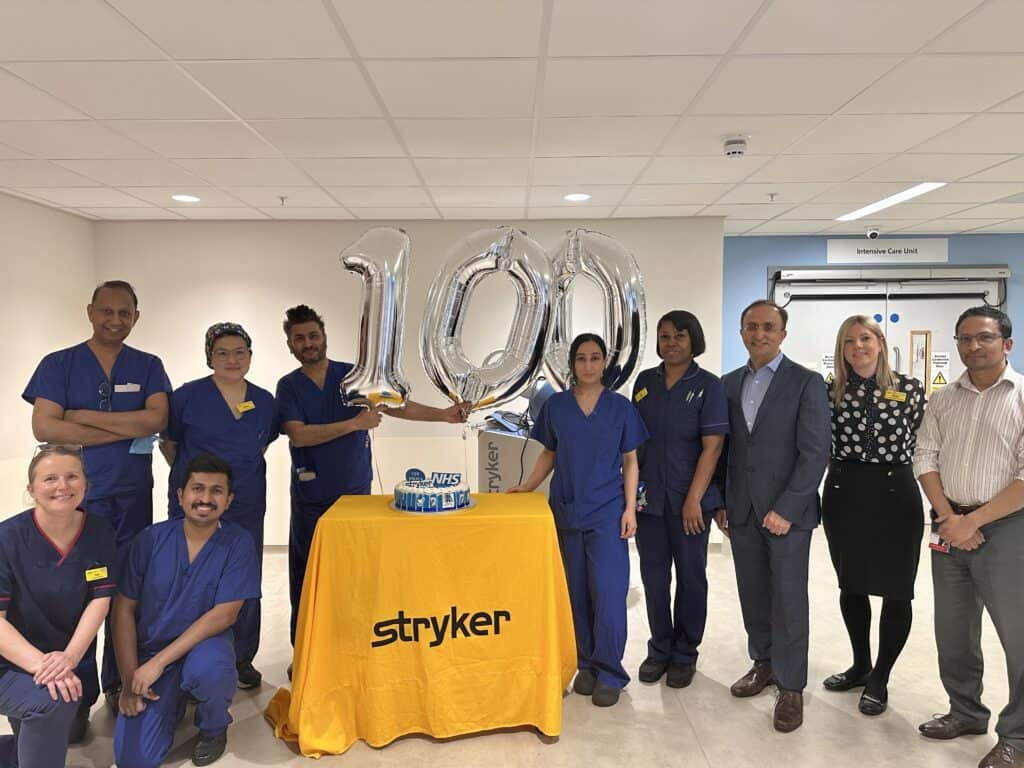 Surgical teams with balloons spelling out 100