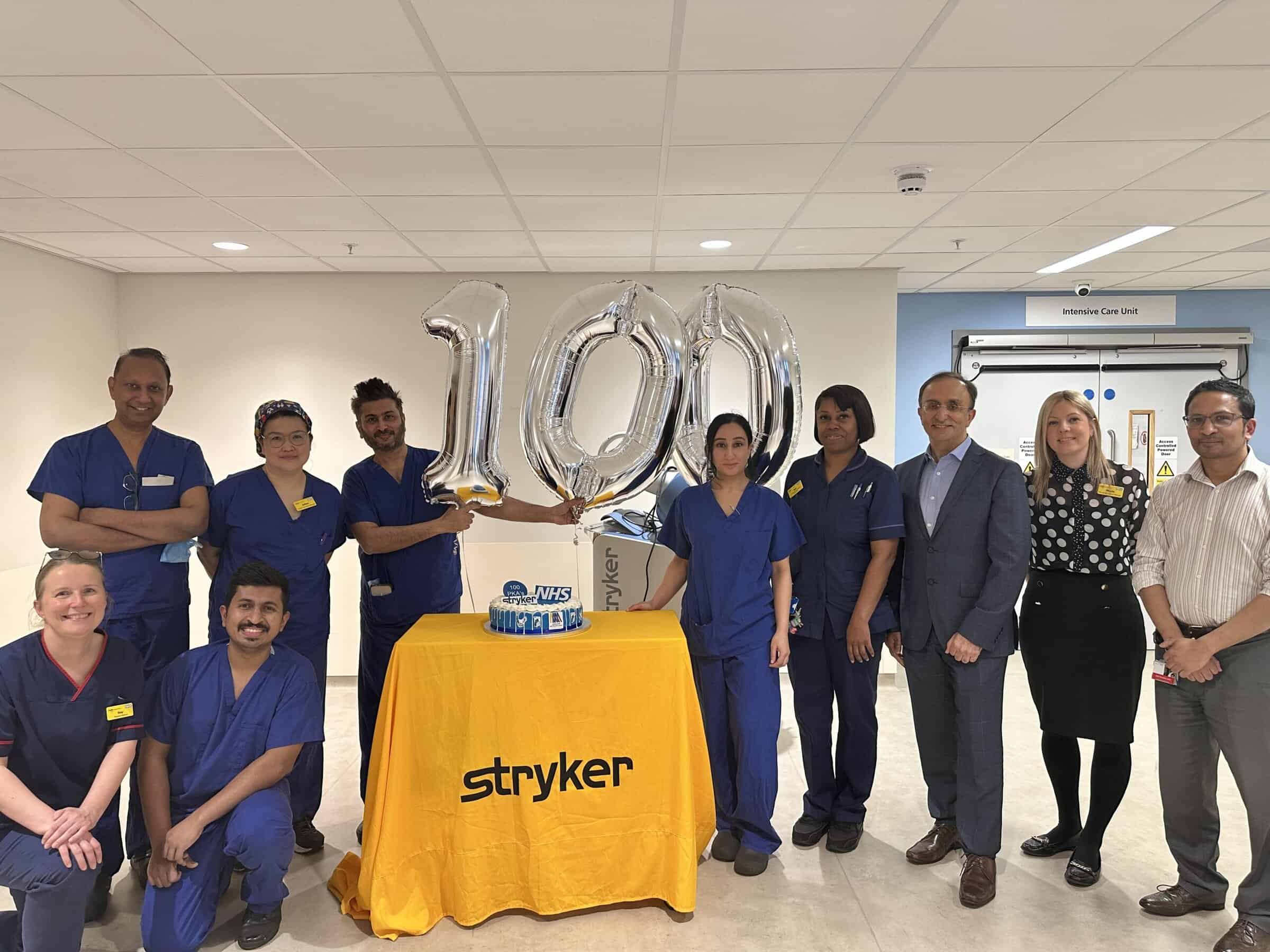 Surgical teams with balloons spelling out 100