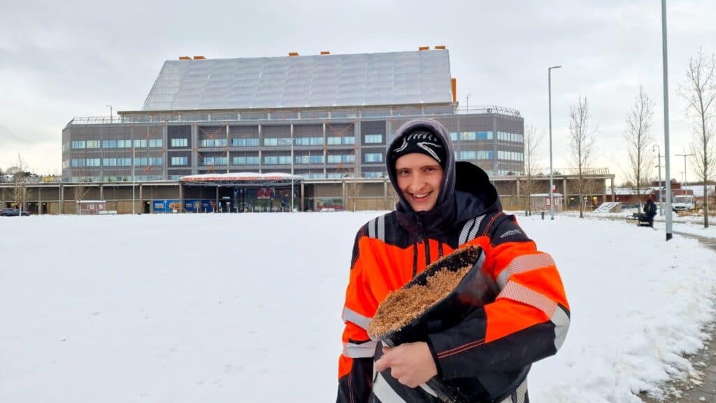 A photo of a staff member outside a hospital in the snow