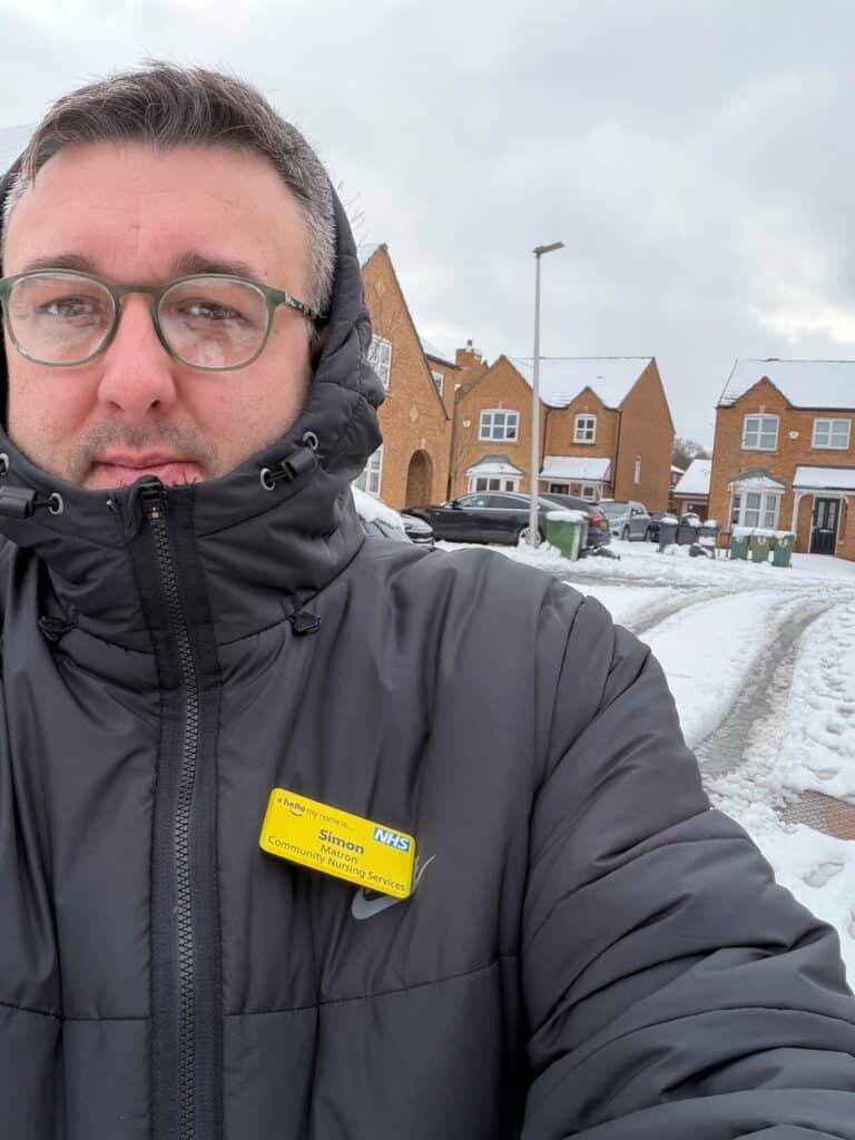 A photo of a community matron outside in the snow.