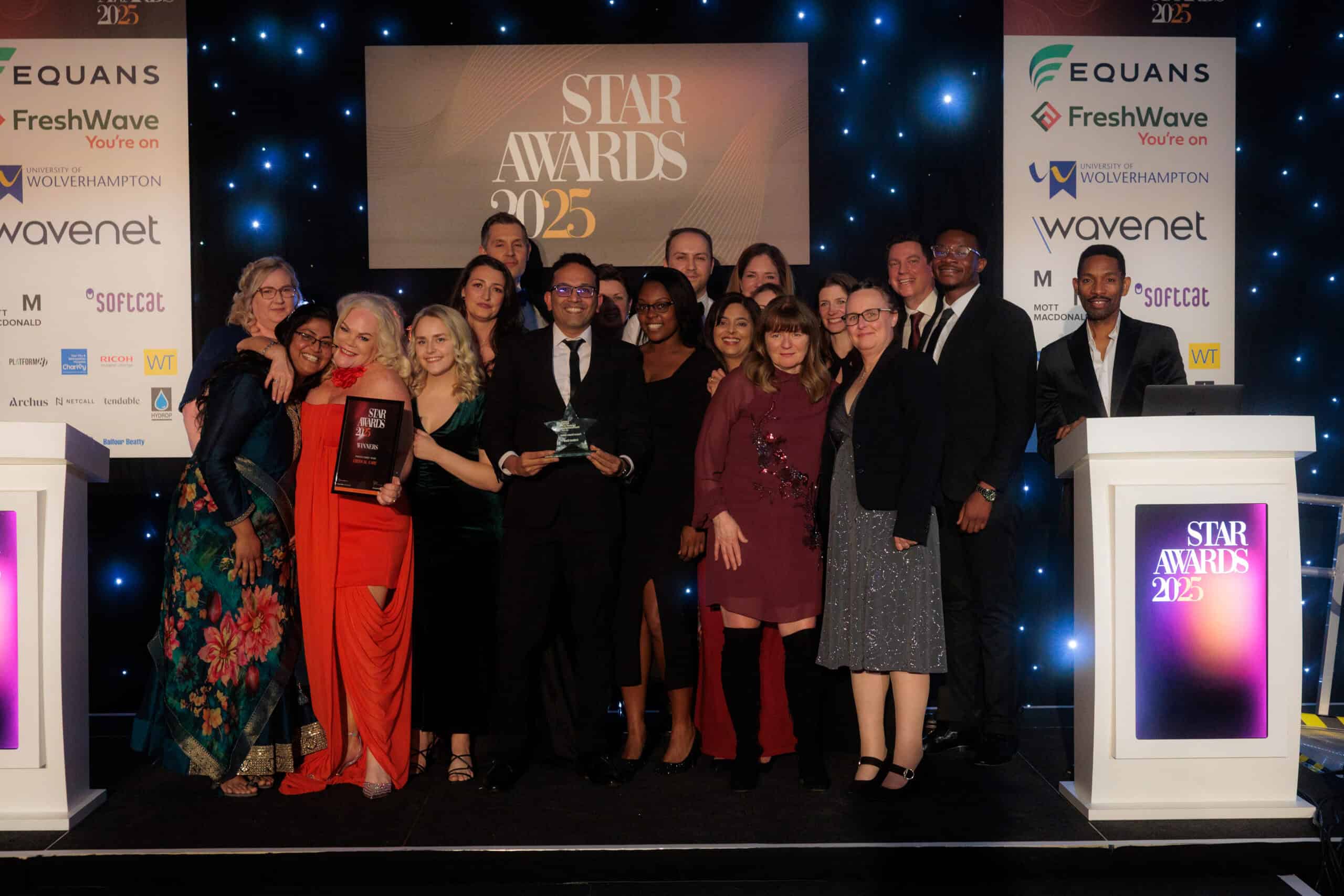 A photo of group of people on stage, winning an award at Sandwell and West Birmingham NHS Trust's annual Star Awards.