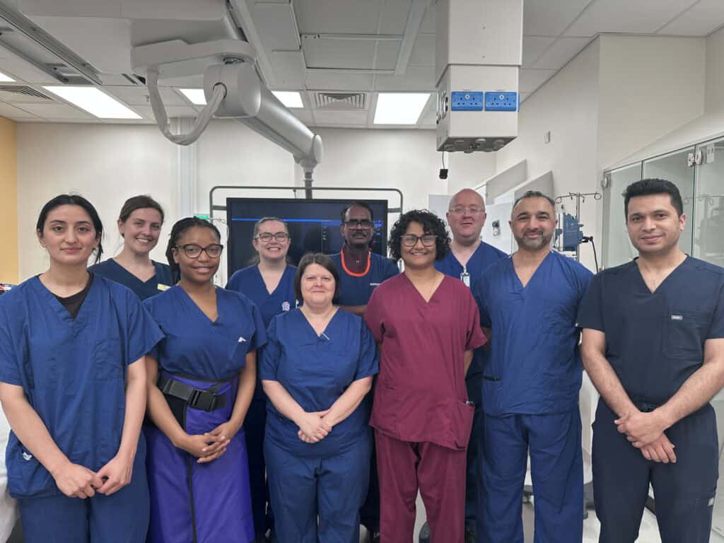 A group of cardiology clinicians in a cardiac catheter lab