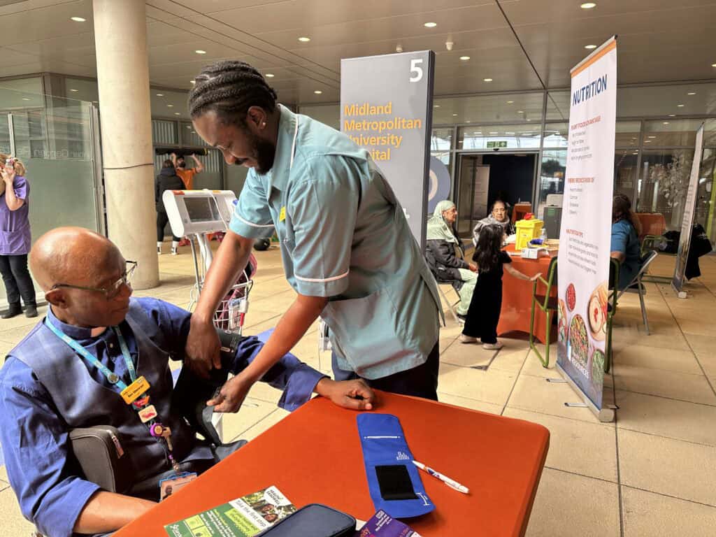 A man receiving a blood pressure check.